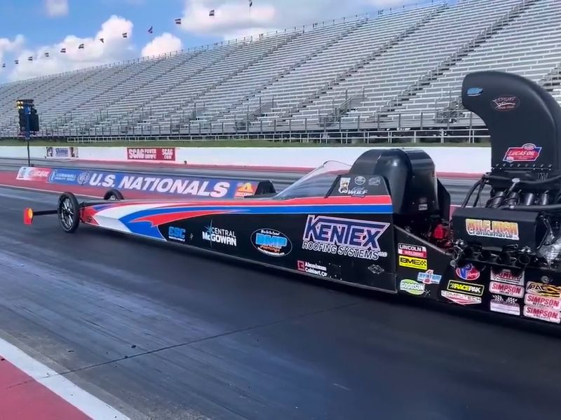 The DMP Awnings and Kentex Roofing Top Alcohol Dragster staged on the starting line at a 2026 test session