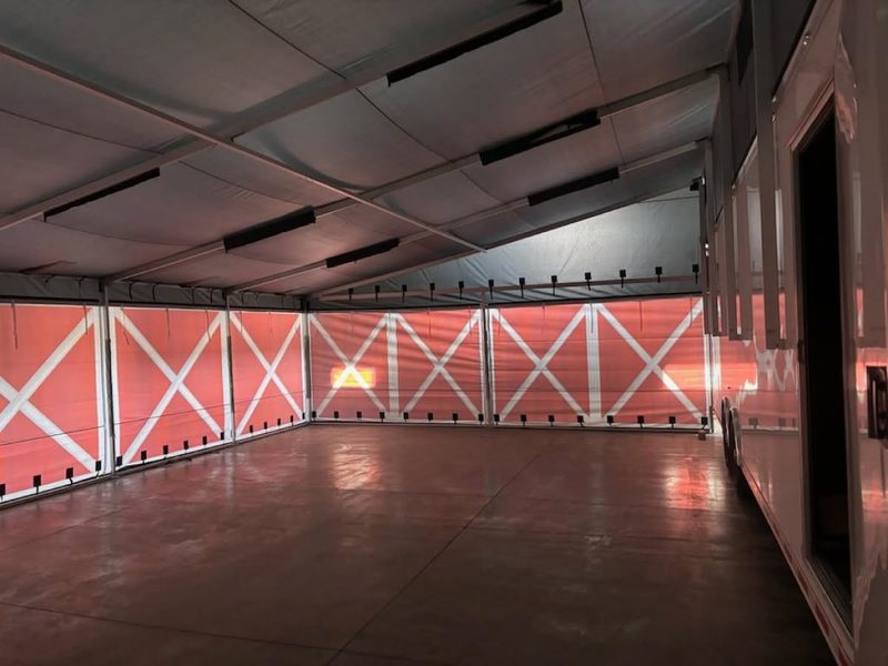 Inside a fully enclosed DMP trailer awning with printed side walls