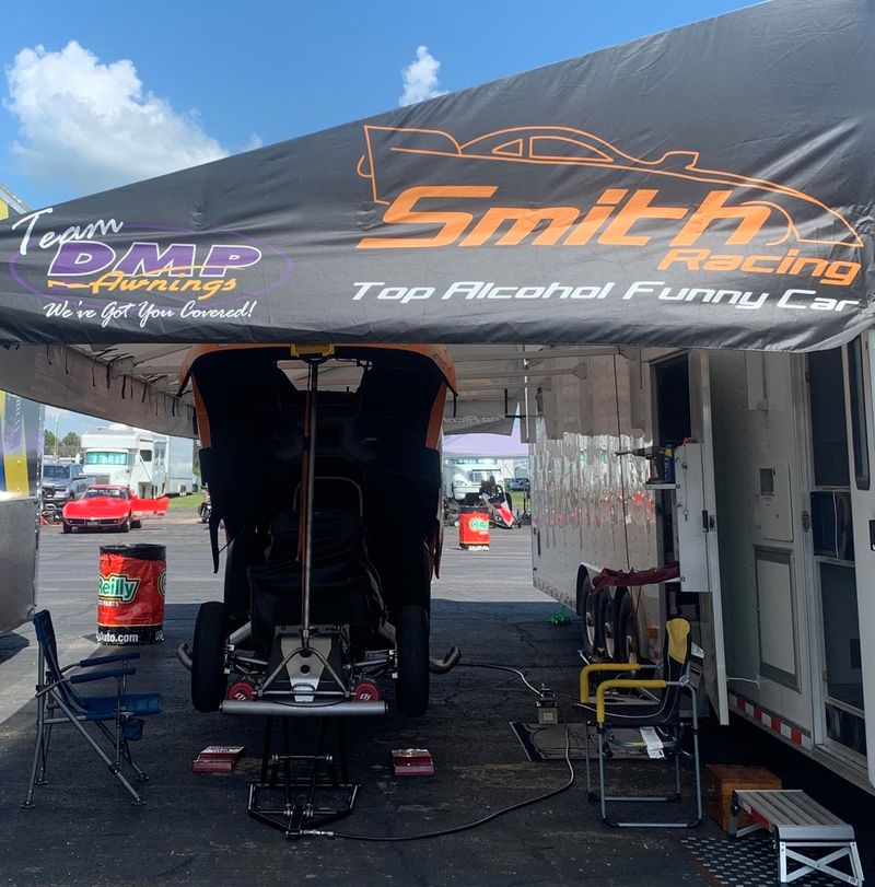 Smith Racing Top Alcohol Funny Car awning printed with the team name and a Team DMP logo