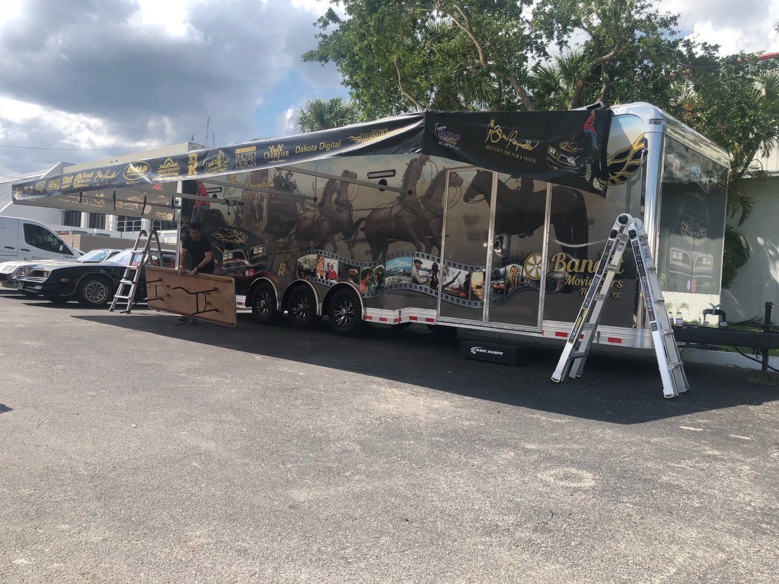 DMP race trailer awning being set up in the pits with custom aluminum work area